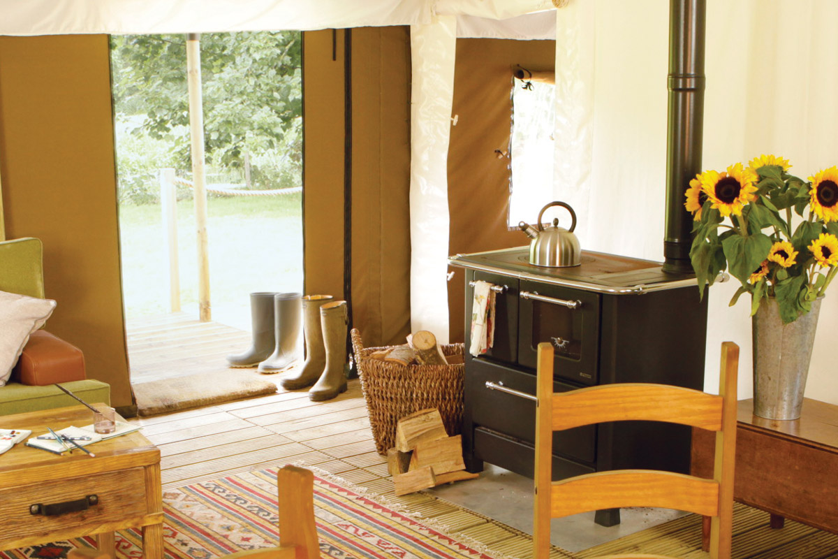The log burning stove in the main room of the tent has a hob